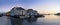 Old colorful houses on the waterfront in Alesund, Norway in the evening at sunset.