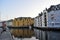 Old colorful houses on the waterfront in Alesund, Norway in the evening at sunset.