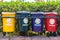 Old Colorful Recycle Bins In The Park. urns for separate collection of garbage