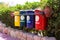 Old Colorful Recycle Bins In The Park. urns for separate collection of garbage