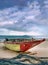 Old colorful wooden fisher boat on an overcast beach