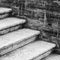 Old concrete stairway goes near brick wall