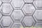 Old concrete wall texture with hexagon shape pattern white grey background with gree grass