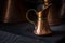 Old copper milk jug for breakfast with coffee with dark background