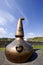 Old copper still at the entrance of the Ardbeg whisky distillery on the isle of Islay