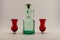 Old corked bottle and red shot glasses