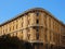 Old Corner Apartment Building with Blue Sky