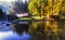 Old cottages under colorful trees and river