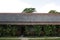 Old country house with red tiles roof, white walls, wooden porch