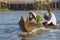 Old couple cross Mekong river by motorboat, Cai Be, Vietnam.