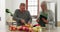 Old couple in kitchen, cooking with tablet and help, online recipe for vegetables and conversation. Healthy food, senior