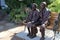 Old couple sitting side by side sculpture, Chemainus