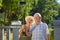 Old couple taking selfie, summer.