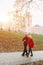 Old couple is walking in the green park. Fifty years together love story. Grandma and grandpa kissing. Grandmother and grandfather