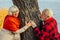 Old couple is walking in the green park. Fifty years together love story. Grandma and grandpa kissing. Grandmother and grandfather