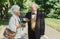 Old couple is walking in the green park. Grandmother and grandfather at their golden wedding anniversary celebration. Fifty years