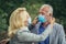 Old couple wearing protective face masks outdoors