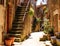 Old courtyard in Pitigliano with vases with flowers and with st