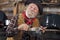 Old cowboy stirs saucepan in outdoor kitchen