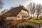 Old cozy house with thatched roof in Giethoorn, Netherlands