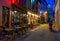 Old cozy narrow street with tables of restaurant in historic city center of Antwerpen Antwerp, Belgium.