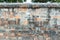 Old crack obsolete brick wall fence with gray stone cement stained background texture nobody