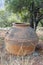 An old cracked huge ceramic clay jug as a decorative element in the garden.