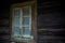 Old creepy scary window on wooden house. Halloween, haunted house concept