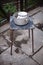 Old crockery on a retro stool. Aluminum pan and enameled mug on a chair. Rural yard