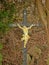 Old cross with jesus statue along the road in Harze, Belgium