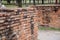 Old crumbling overgrown brick wall