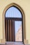 Old curved window with wooden shutters