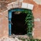 Old damaged abandoned house. Window without glass