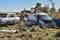 Old damaged cars in the junkyard. Car graveyard