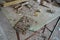 Old damaged dusty soviet electrical circuit boards on the table in abandoned factory of radio components