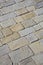 Old and damaged italian paving made with chiseled grey sandstone