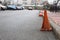 An old damaged traffic cone on the road.