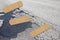 Old dangerous damaged cracked asphalt road surface with patch - concept image with adhesive bandage