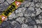 Old dangerous damaged cracked asphalt road surface with patch - concept image with danger text on it