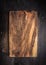 Old dark cutting board on brown wooden table