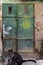 Old Dark green emerald metal dirt door with keyhole and rusty metal lockas a beautiful vintage background