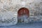 Old decadent wooden door on an ancient stone wall in mountain region of Aragon. Sallent de Gallego village, Huesca, Spain