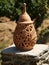 Old decorative clay candle holder on a stone