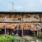 Old and derelict wooden terraced house with food stall