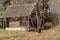 Old deserted, desolate wooden vintage house on the fringe of the forest of the picturesque forest in autumn. Solitary