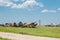 Old destroyed abandoned airplanes and helicopters in the field, cemetery of old helicopters and planes