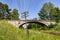 Old destroyed concrete overpass over the railway line. Old railway line with a telegraph line