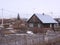 the old destroyed rural house with dirty yards of the wooden fences in the spring