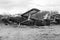 Old destroyed Soviet abandoned military airplanes in the field in Ukraine, black and white