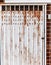 Old detailed aged vintage rusty brown textured steel alloy door stretch of traditional Asian commercial building store front.